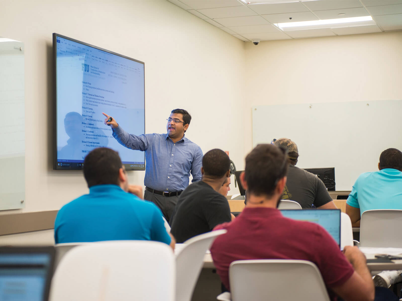 A photo of an FIU professor teaching in a classroom