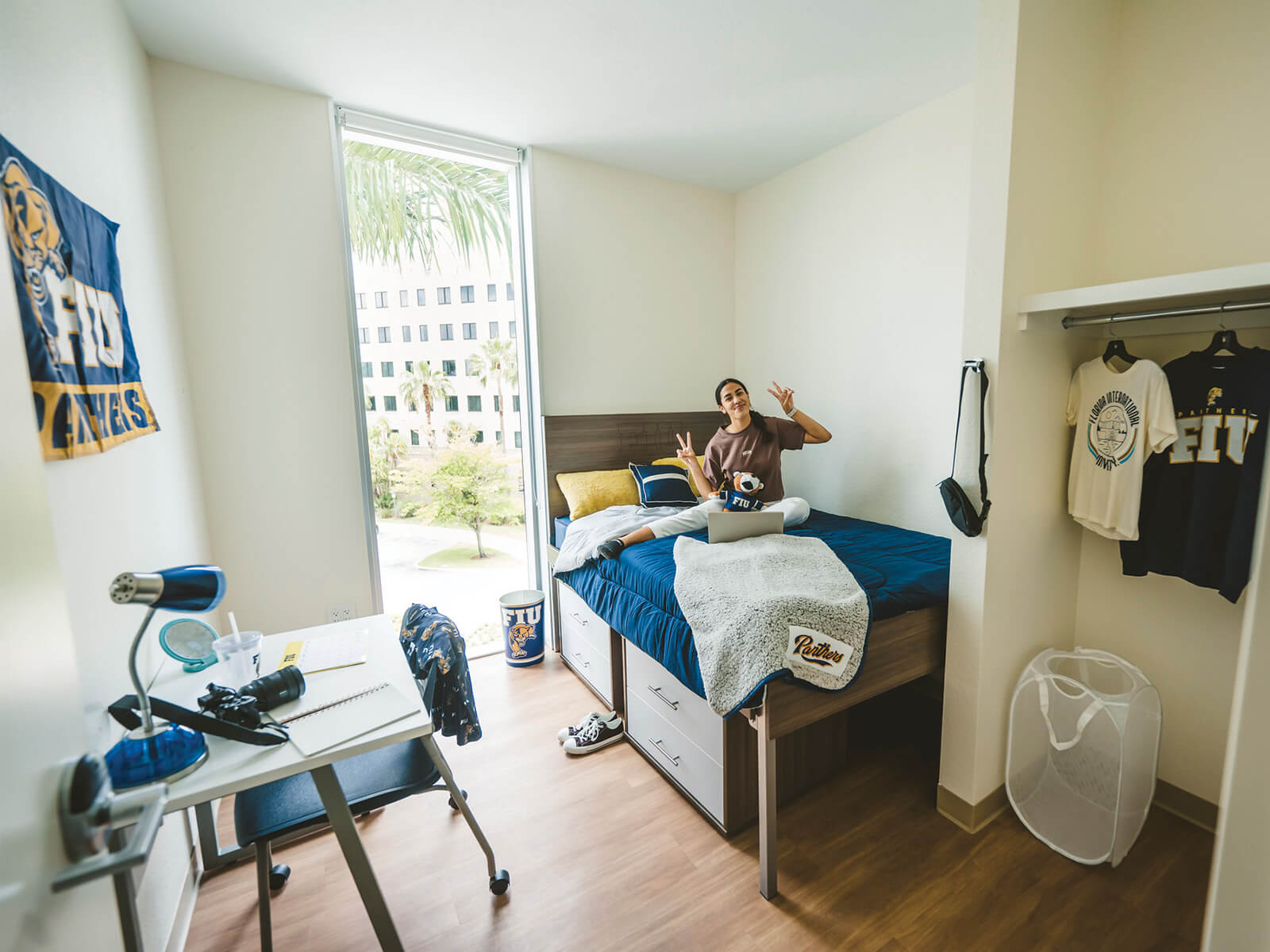 A photo of a student sitting in her dorm room on FIU MMC. 