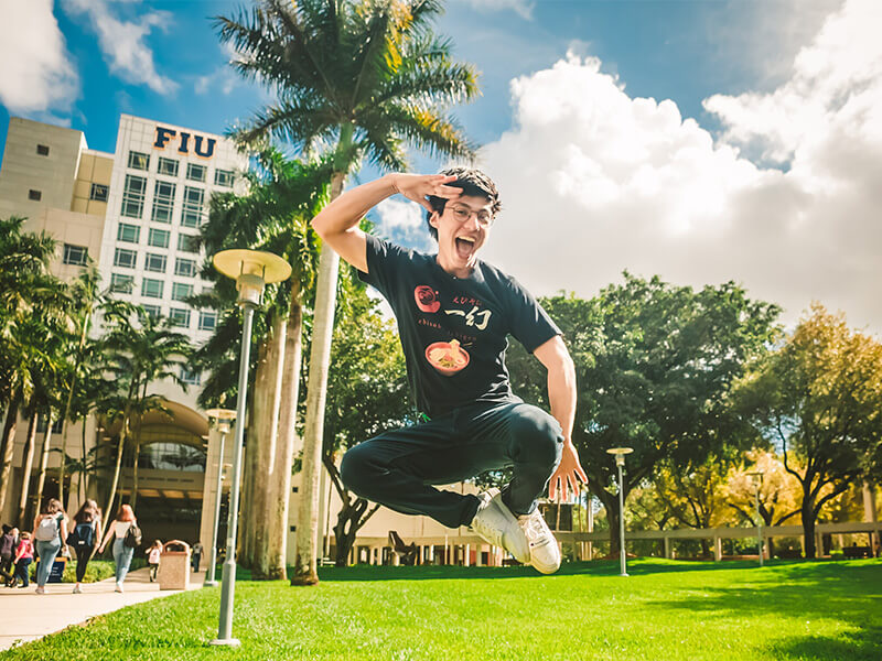 FIU student jumping in the air