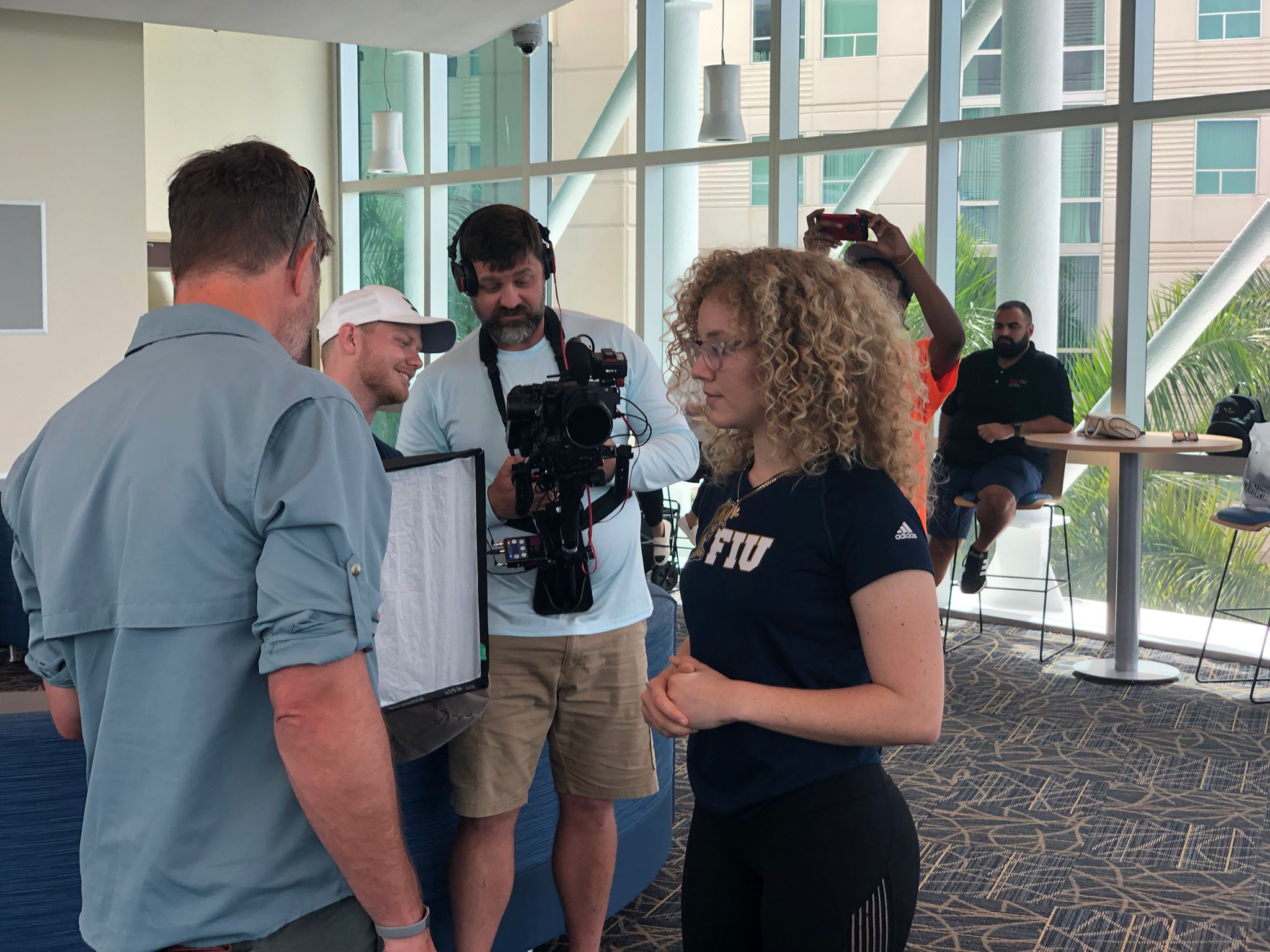 Delaney Dockstader (right) waits as production reviews footage between takes.