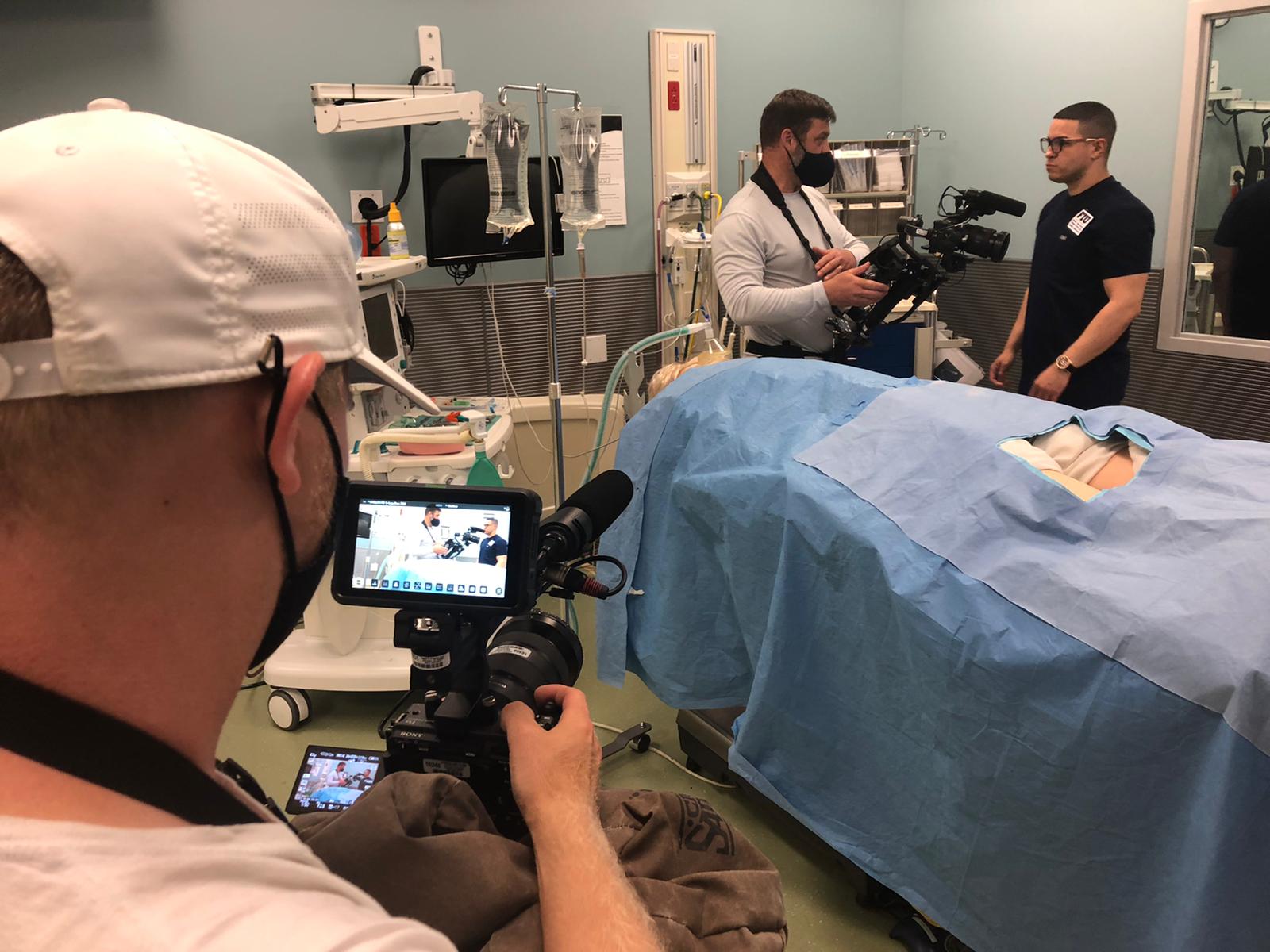 Carlos Vasco prepares for his shot in a simulated emergency room setting