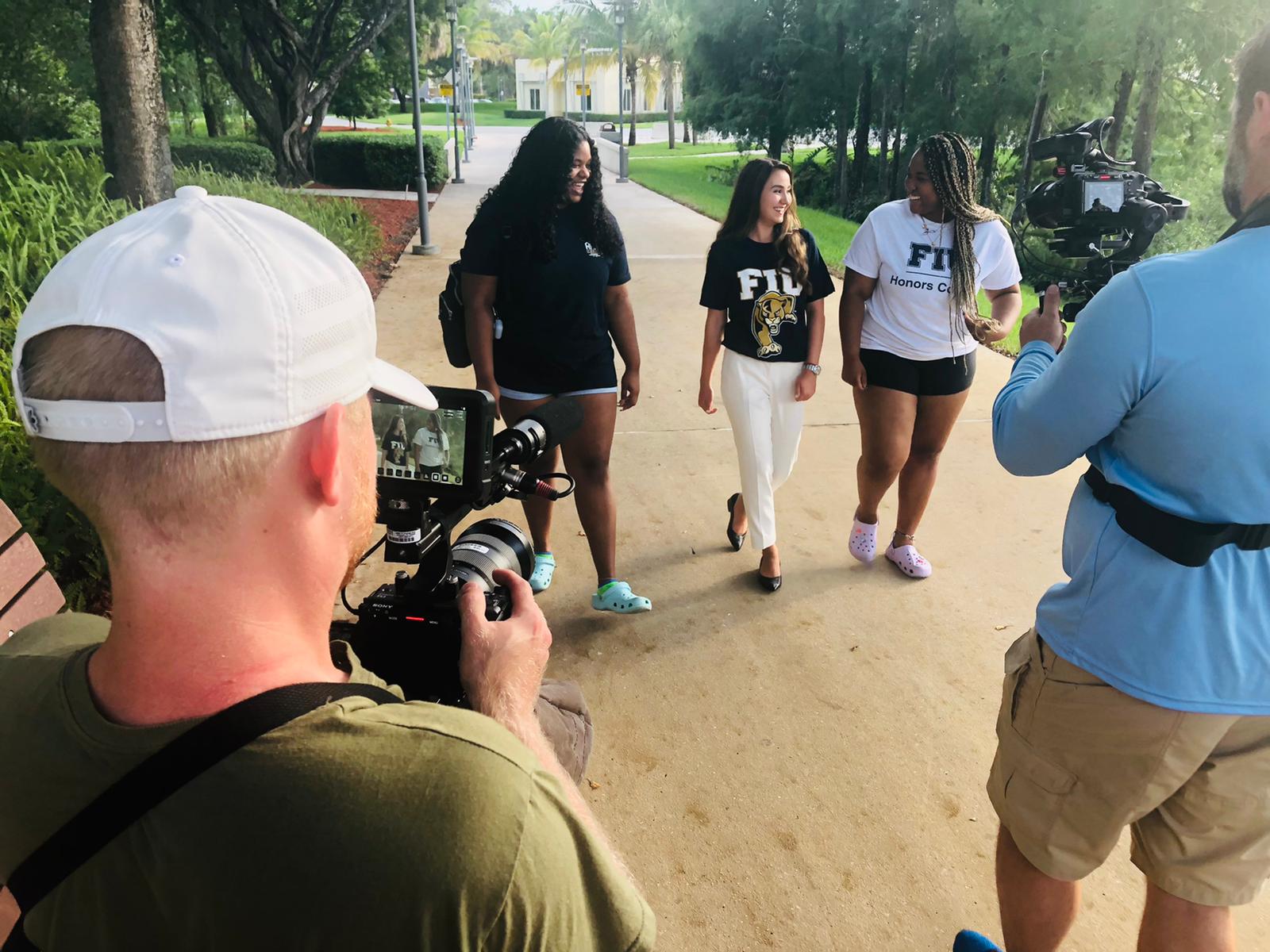 Juliana Cazzaniga walks around Florida International University’s Modesto A. Maidique Campus with classmates as she films her segment.