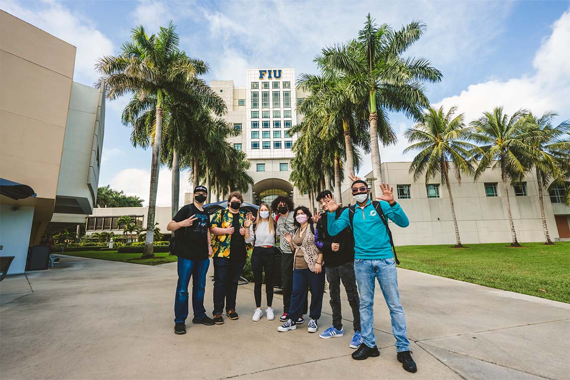 A group of students standing in front of the Green Library